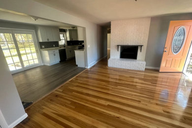 Living room - mid-sized 1960s open concept living room idea in Boston with a standard fireplace and a brick fireplace