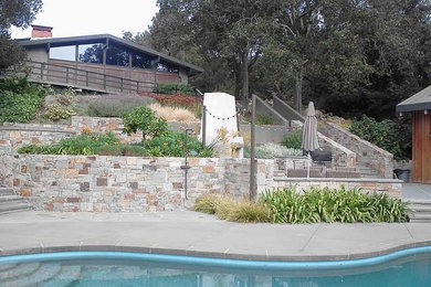 This is an example of a mid-sized traditional backyard patio in San Diego with concrete slab, no cover and a fire feature.