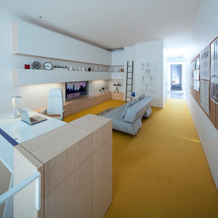 Design ideas for a large modern study in Vancouver with white walls, carpet, no fireplace, a built-in desk and yellow floors.