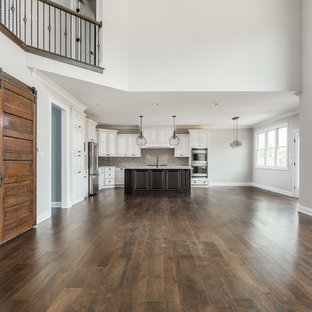 Large craftsman kitchen pantry photos - Kitchen pantry - large craftsman l-shaped dark wood floor kitchen pantry idea in Indianapolis with an undermount sink, raised-panel cabinets, white cabinets, granite countertops, multicolored backsplash, mosaic tile backsplash, stainless steel appliances and an island