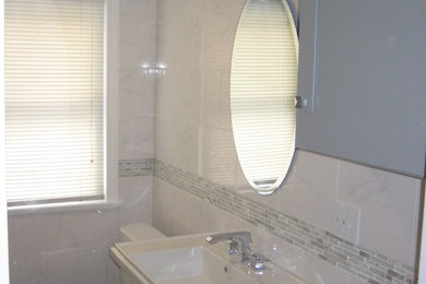 Inspiration for a mid-sized transitional 3/4 white tile and marble tile porcelain tile and gray floor bathroom remodel in Boston with flat-panel cabinets, gray cabinets, a two-piece toilet, white walls and a pedestal sink
