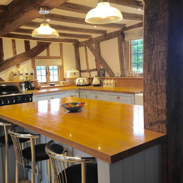 A charming, blue country kitchen installation with large island