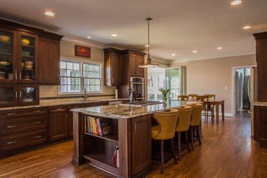 Open concept kitchen - mid-sized rustic single-wall medium tone wood floor open concept kitchen idea in Atlanta with shaker cabinets, dark wood cabinets, granite countertops, white backsplash, an island, an undermount sink, subway tile backsplash and stainless steel appliances