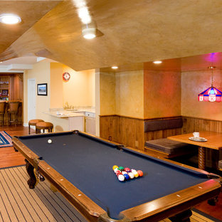 Inspiration for an expansive traditional fully buried basement in New York with beige walls, medium hardwood flooring and orange floors.