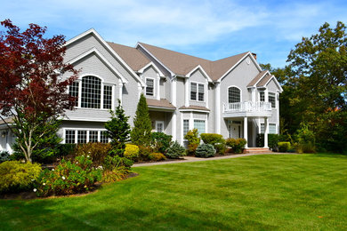 Inspiration for a large timeless gray two-story wood exterior home remodel in Boston with a shingle roof