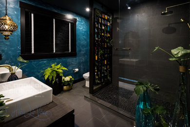 Bathroom - mid-sized contemporary master brown tile and ceramic tile ceramic tile and brown floor bathroom idea in Vancouver with furniture-like cabinets, dark wood cabinets, a one-piece toilet, brown walls, a wall-mount sink, wood countertops and brown countertops
