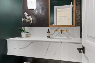 Small minimalist black tile and ceramic tile ceramic tile and gray floor powder room photo in Ottawa with white cabinets, a one-piece toilet, green walls, an integrated sink, quartz countertops, white countertops and a floating vanity