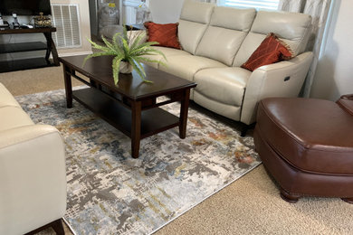 Inspiration for a modern enclosed living room with beige walls and carpet.