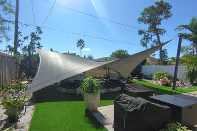 Patio - mid-sized tropical backyard patio idea in Miami