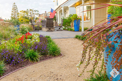 Patio - small traditional front yard concrete paver patio idea in Orange County with a fire pit