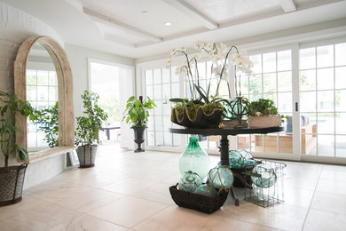 Large elegant entry hall photo in Los Angeles with white walls
