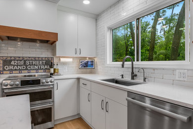 Eat-in kitchen - large transitional light wood floor eat-in kitchen idea in DC Metro with an undermount sink, white cabinets, marble countertops, white backsplash, ceramic backsplash, stainless steel appliances, an island and white countertops