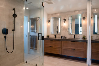 Inspiration for a large modern master beige tile and ceramic tile ceramic tile, beige floor and double-sink bathroom remodel in San Diego with shaker cabinets, dark wood cabinets, white walls, an undermount sink, quartz countertops, a hinged shower door, gray countertops and a floating vanity