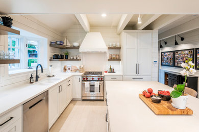 Large cottage l-shaped ceramic tile, beige floor and exposed beam kitchen photo in Vancouver with a double-bowl sink, shaker cabinets, white cabinets, quartz countertops, white backsplash, shiplap backsplash, stainless steel appliances, an island and white countertops