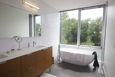 Example of a large minimalist master white tile and ceramic tile ceramic tile and gray floor bathroom design in Orange County with furniture-like cabinets, light wood cabinets, a wall-mount toilet, white walls, an undermount sink, quartz countertops, a hinged shower door and white countertops