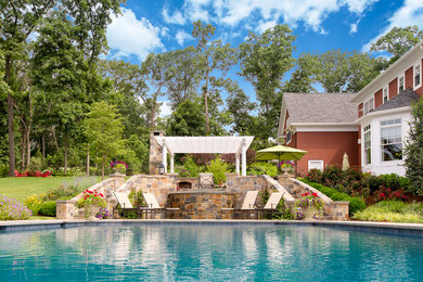 Inspiration for a large traditional backyard rectangular pool in New York with natural stone pavers.