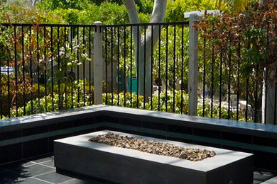 Patio - modern patio idea in Orange County with a fire pit