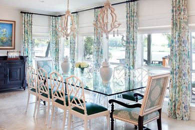 Photo of a beach style dining room in Austin with white walls and beige floor.