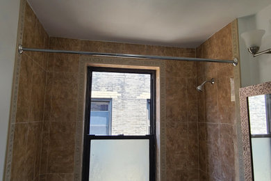 Example of a tuscan master multicolored tile and porcelain tile porcelain tile, brown floor and single-sink bathroom design in New York with recessed-panel cabinets, dark wood cabinets, multicolored walls, an integrated sink, quartz countertops, white countertops, a niche and a freestanding vanity