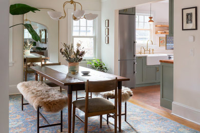 Kitchen/dining room combo - mid-sized 1960s medium tone wood floor and brown floor kitchen/dining room combo idea in Portland with white walls and no fireplace