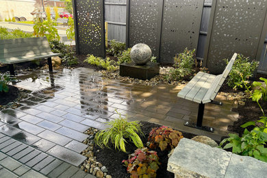Inspiration for a small asian shade courtyard concrete paver and metal fence landscaping in Providence.