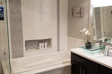Large transitional master white tile and ceramic tile porcelain tile and brown floor bathroom photo in San Francisco with recessed-panel cabinets, dark wood cabinets, gray walls, a vessel sink, quartz countertops, a hinged shower door and white countertops