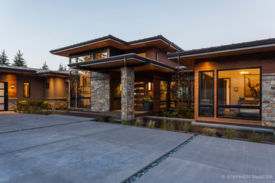 This is an example of a huge contemporary porch design in Portland with decking and a roof extension.