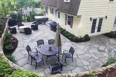 This is an example of a large traditional backyard patio in Other.