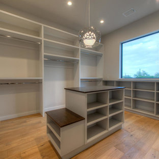 Inspiration for a large modern gender-neutral light wood floor dressing room remodel in Austin with flat-panel cabinets and gray cabinets