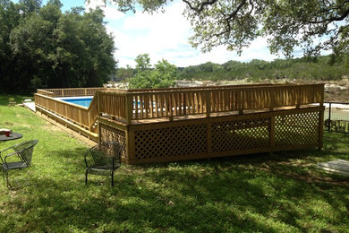 Inspiration for a large timeless backyard rectangular pool remodel in Austin with decking