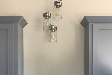 Cottage eat-in kitchen photo in Oklahoma City with a farmhouse sink, beaded inset cabinets, gray cabinets, granite countertops, gray backsplash, ceramic backsplash, stainless steel appliances and an island
