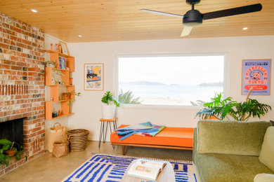 Example of a 1960s open concept concrete floor, gray floor and wood ceiling family room design in Seattle with white walls, a standard fireplace and a brick fireplace