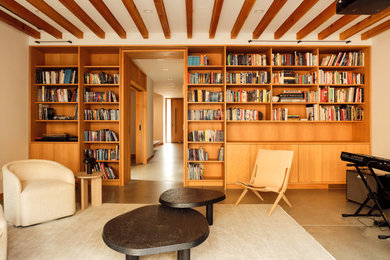 Example of a trendy open concept concrete floor, gray floor and exposed beam living room design in San Francisco with beige walls