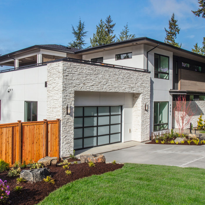This great home is situated on a corner lot with amazing views of Meydenbauer Bay from several vantage points throughout the home.  The mix of exterior materials adds depth and interest to the exterio