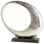 Cyan Design - Large Clearly Through Sculpture - Evoking a crescent moon, this abstract circle sculpture features an open center and a wonderful raw nickel finish. Crafted in aluminum, the large sculpture sits on a block base with a dark finish that allows the piece to speak for itself.