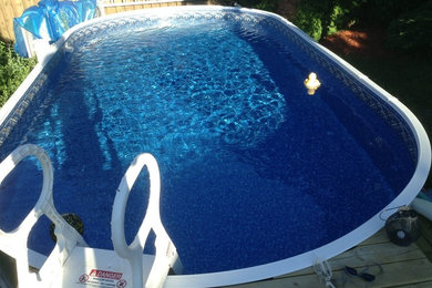 Pool - traditional backyard round aboveground pool idea in Toronto with decking