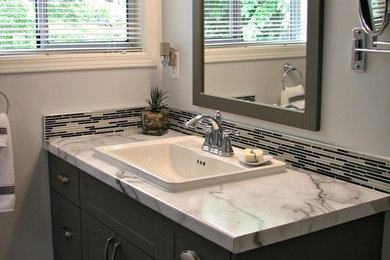 Mid-sized transitional 3/4 bathroom in Vancouver with shaker cabinets, dark wood cabinets, black and white tile, glass sheet wall, grey walls, ceramic floors, a drop-in sink and laminate benchtops.