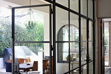Example of a large trendy backyard patio design in Santa Barbara with a roof extension