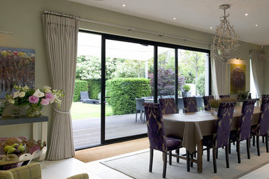 Photo of a large contemporary open plan dining in London with porcelain floors and grey floor.