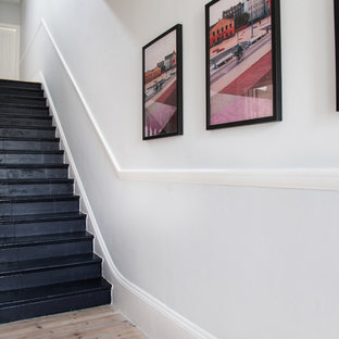 Design ideas for a small modern straight staircase in London with slate treads and wood risers.