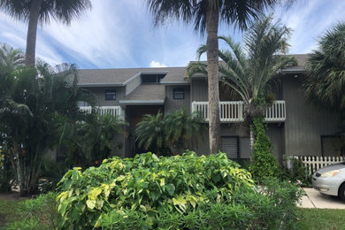 Large contemporary green two-story concrete fiberboard exterior home idea in Other