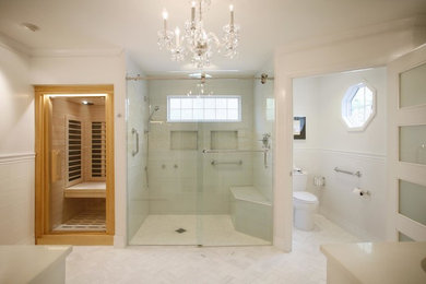 Photo of a large transitional master bathroom in Atlanta with recessed-panel cabinets, white cabinets, an alcove shower, white tile, porcelain tile, white walls, porcelain floors, an undermount sink, solid surface benchtops, white floor, a hinged shower door and a two-piece toilet.