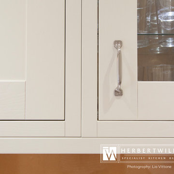 Ivory Mackintosh kitchen with stunning copper glass splashback