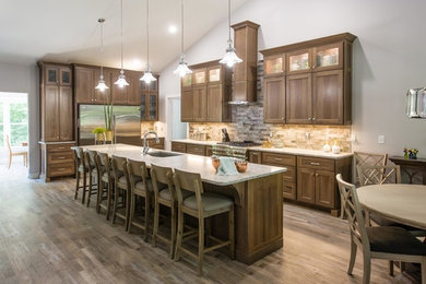 Example of a transitional l-shaped open concept kitchen design in Other with an undermount sink, shaker cabinets, stainless steel appliances and an island