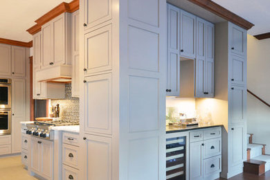 Elegant ceramic tile kitchen photo in Other with recessed-panel cabinets, gray cabinets, quartzite countertops, multicolored backsplash, stone tile backsplash, stainless steel appliances and an island