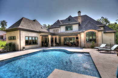 This is an example of a transitional backyard custom-shaped pool in Other with tile.
