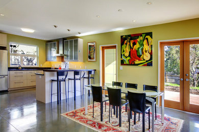 Eat-in kitchen - mid-sized traditional u-shaped eat-in kitchen idea in Seattle with glass-front cabinets, green backsplash, stainless steel appliances and a peninsula