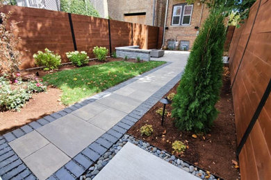 Patio - modern backyard brick patio idea in Chicago with a fire pit