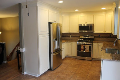 Eat-in kitchen - small modern u-shaped travertine floor and beige floor eat-in kitchen idea in Baltimore with an undermount sink, raised-panel cabinets, white cabinets, granite countertops, beige backsplash, ceramic backsplash, stainless steel appliances, no island and beige countertops