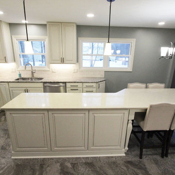 Beige Kitchen with Extra Large Island, Tile Backsplash and Granite Countertops